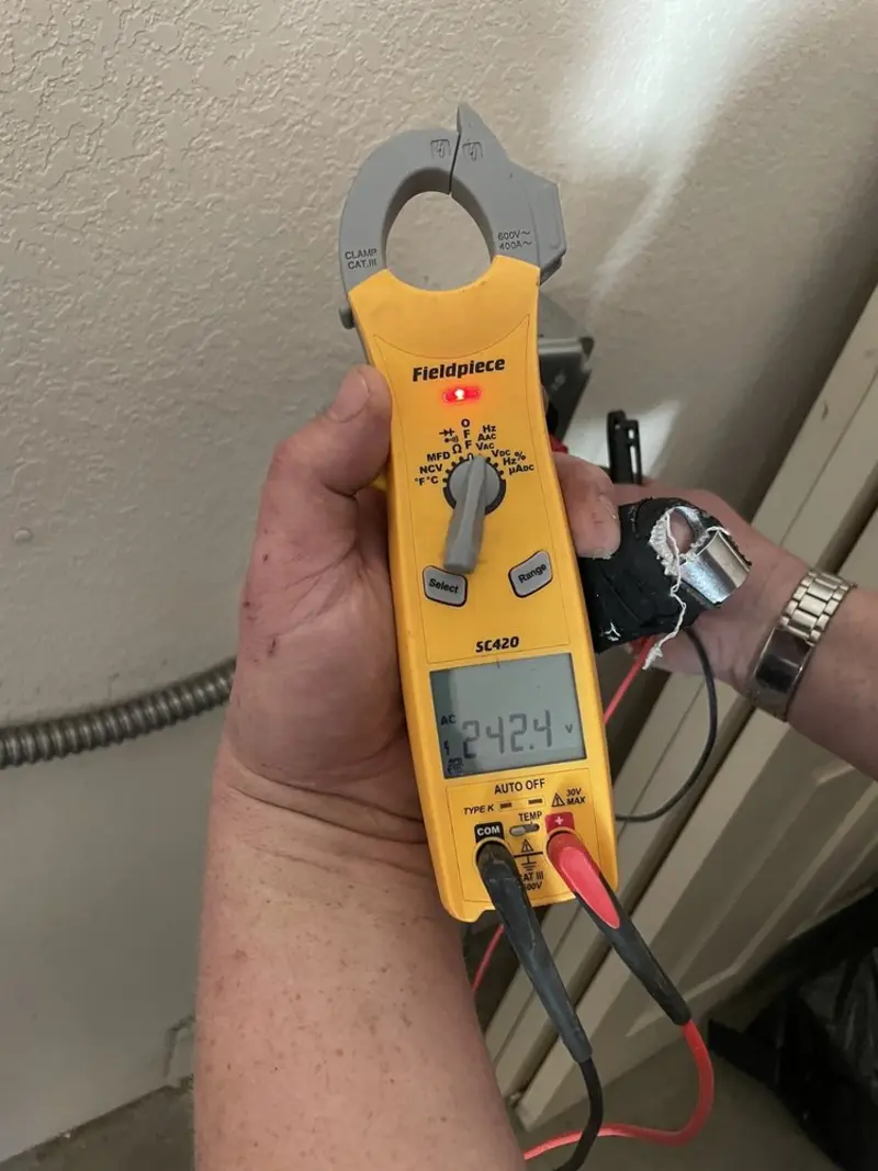 Voltage testing with clamp meter during Whole House Surge Protector in Sylvester